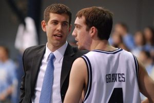 Coach Brad Stevens talking to AJ Graves at Butler University game. 